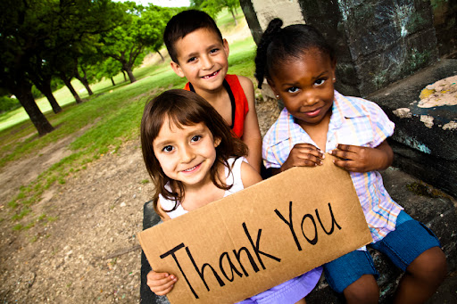 Children holding thank you sign